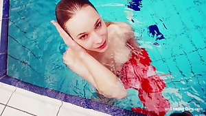 Stunning babe Avenna is stripping and swimming under the water