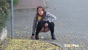 Cute girl walking down the street takes a piss
