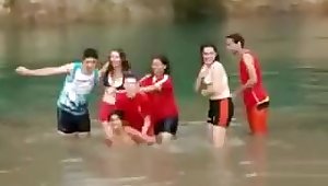 Friends swim in the lake in their underwear
